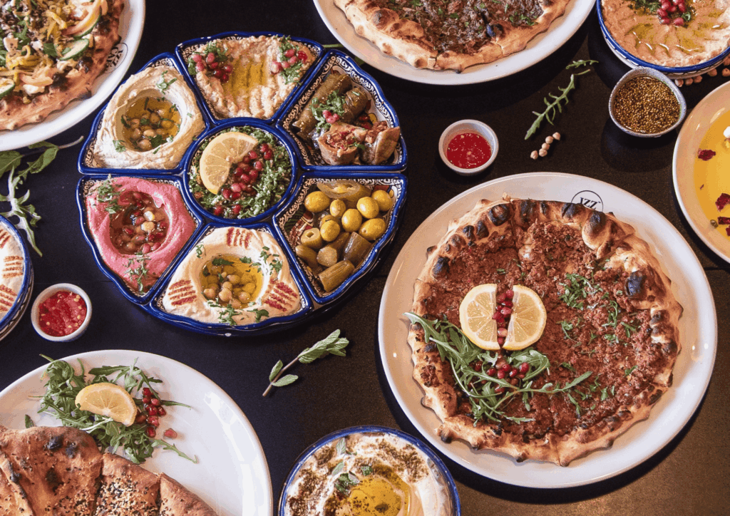 A photo, taken from above, of several dishes on a table prepared by Izz Café
